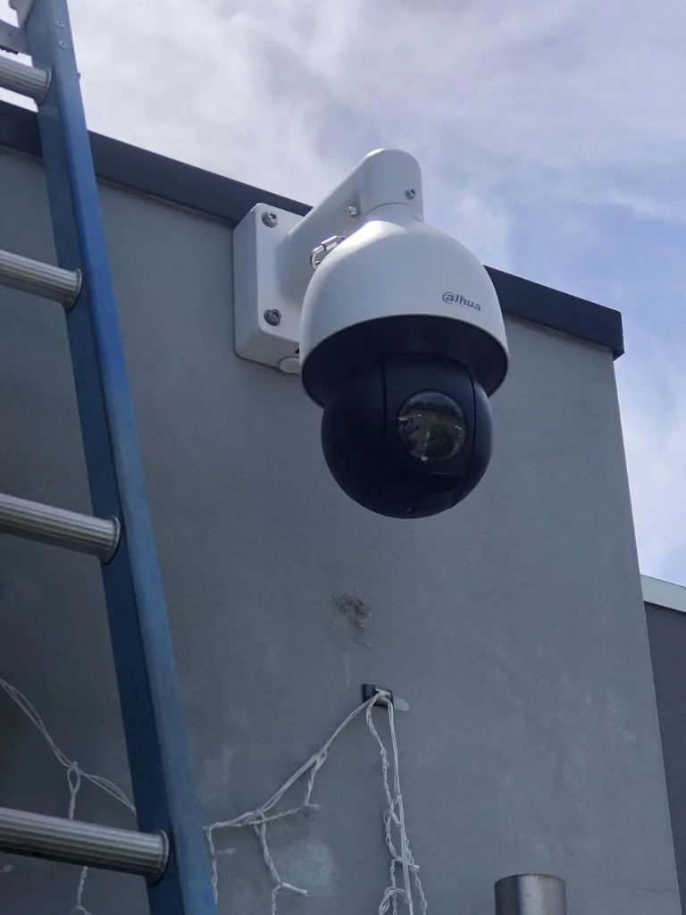 PTZ security camera on a wall bracket with the cable hidden behind the mount